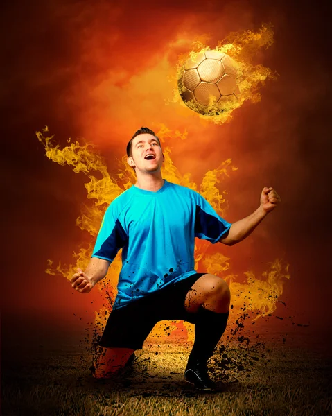 Football player in fires flame on the outdoors field — Stok fotoğraf