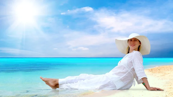 Young beautiful women in the white on the sunny tropical beach Royalty Free Stock Photos