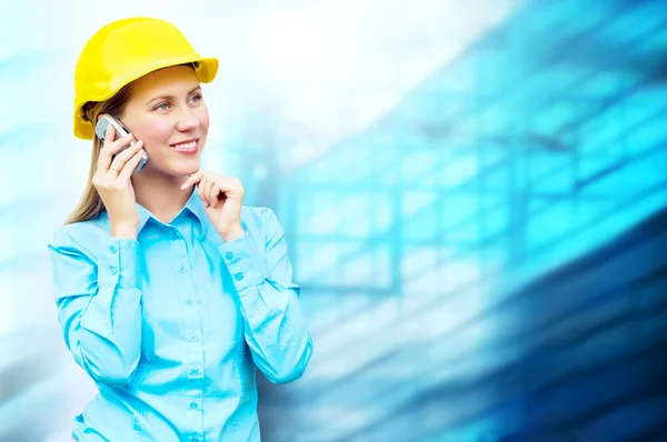 Young architect-woman wearing a protective helmet standing on th Stock Photo
