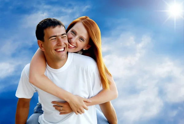 Young love couple smiling under blue sky Royalty Free Stock Photos