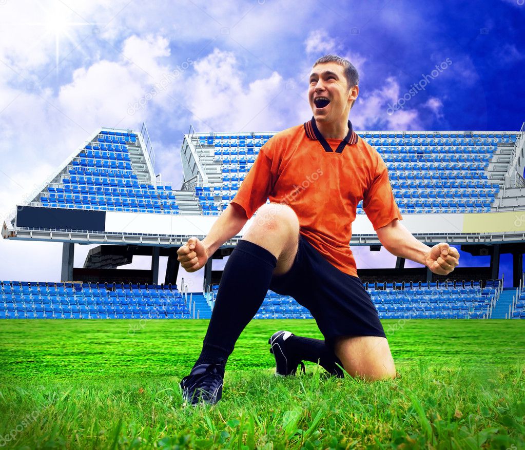 Happiness football player after goal on the field of stadium und