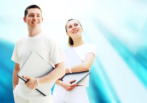 Pair of two happy young or student with laptops on the bu — Stock Photo, Image