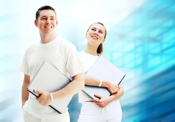 Pair of two happy young or student with laptops on the bu — Stock Photo, Image