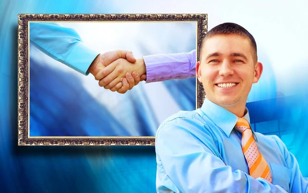 Businessman on the background of picture with two shaking hands — Stock Photo, Image
