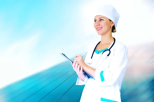 Médecin souriant avec stéthoscope sur le dos des hôpitaux — Photo
