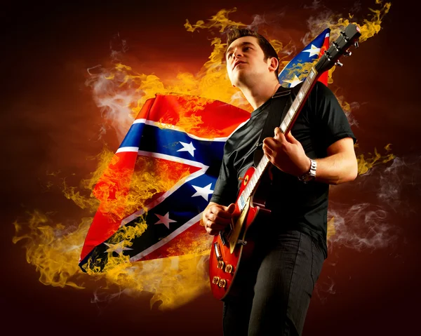 Рок-гітарист грає на електрогітарі навколо полум'я вогню — стокове фото