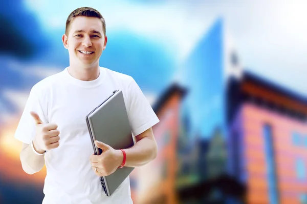 Mladý šťastný muž nebo student s notebookem a telefon na podnikání — Stock fotografie
