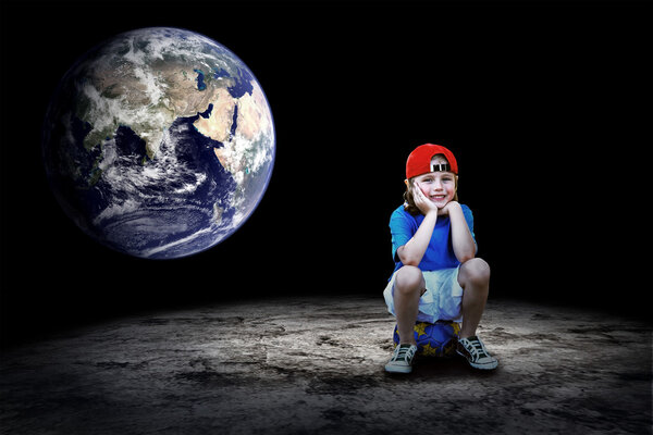 Child football player and Grunge ball on the dark background