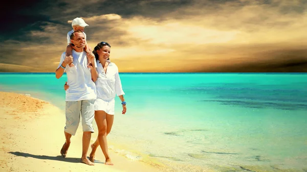View of happy young family having fun on the beach — Stock Photo, Image