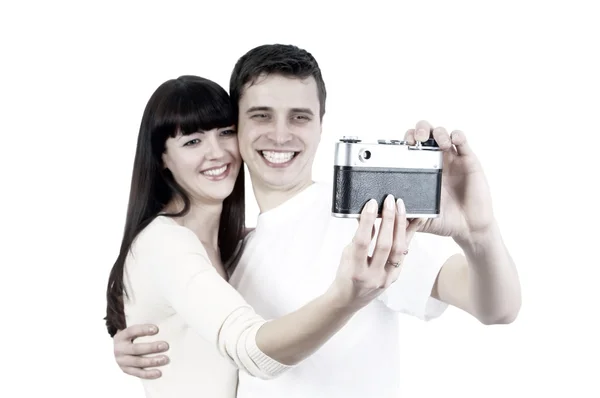 Piękna młoda para z aparatu fotograficznego na białym tle na biały backgrou — Zdjęcie stockowe