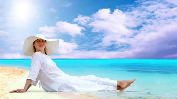 Young beautiful women in the white on the sunny tropical beach Stock Picture