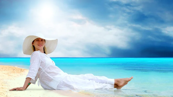 Young beautiful women in the white on the sunny tropical beach Stock Photo