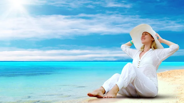 Young beautiful women in the white on the sunny tropical beach Royalty Free Stock Images