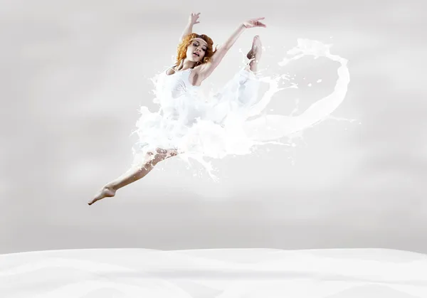 Sprong van ballerina met jurk van melk Stockfoto