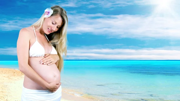 Happiness pregnant women in the white on the sunny tropical beac Stock Photo