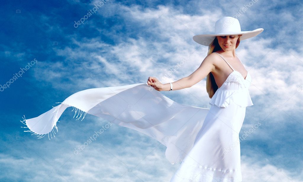 Young beautiful women in the white with pareo on the blue sky ba