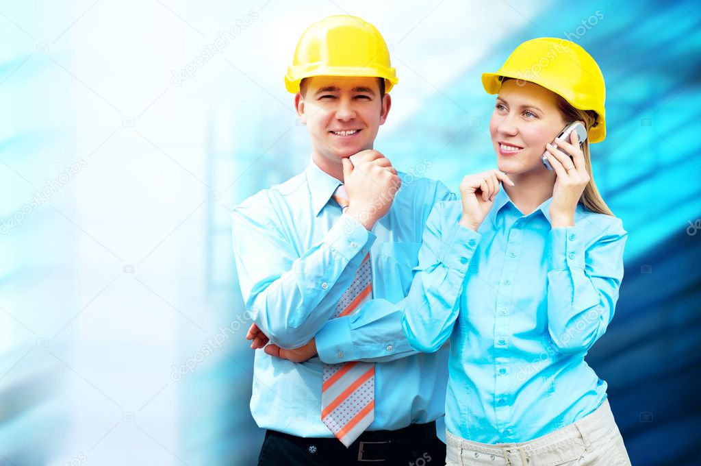 Young architects wearing a protective helmet standing on the bui