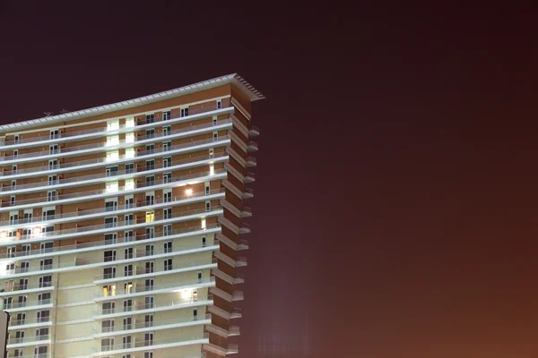 Modern highrise building illuminated at night — Stock Photo, Image