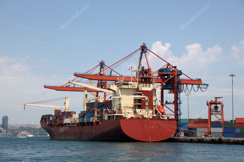 Large container ship in a dock at industrial port (logos and brandnames removed)