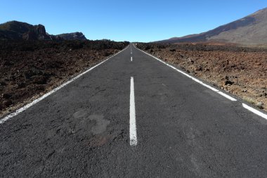 Lonesome road through the volcanic landscape of Tenerife, Spain clipart