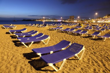 Playa de los Cristianos at dusk. Canary Island Tenerife, Spain clipart