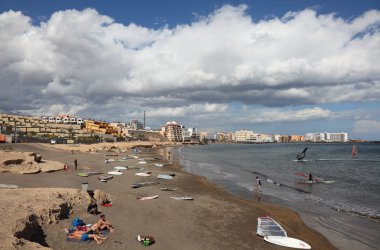 Surfers on the beach of El Medano, Canary Island Tenerife, Spain. Photo tak clipart