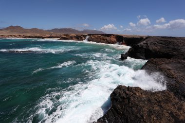 Rocky coastline of the Canary Island Fuerteventura, Spain clipart