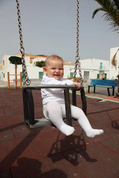 Joyeux bébé fille dans une balançoire — Photo