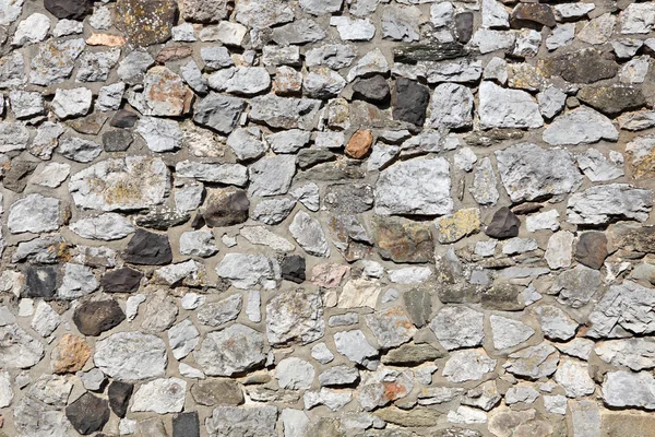 Parede de pedra velha feita de blocos empilhados aleatoriamente — Fotografia de Stock
