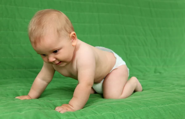 Cute baby girl crawling on the couch — Stock Photo, Image