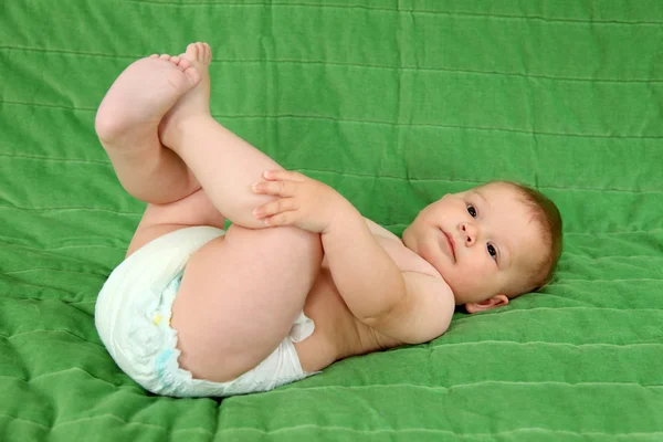 Cute baby girl lying on the couch — Stock Photo, Image