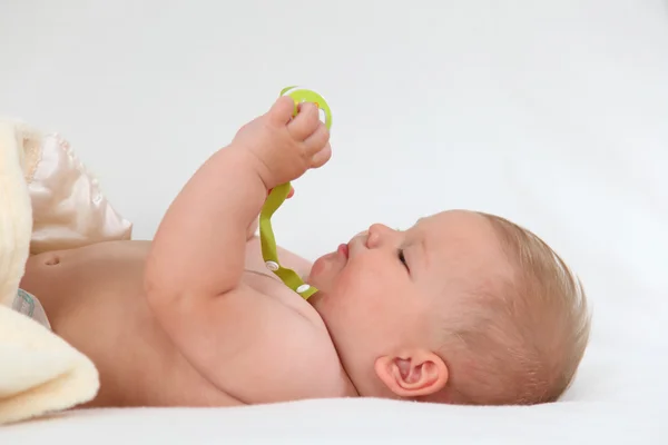 Cute baby girl playing in bed — Stock Photo, Image