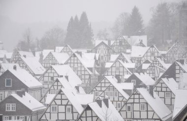 Snow-covered frame houses in German town Freudenberg clipart