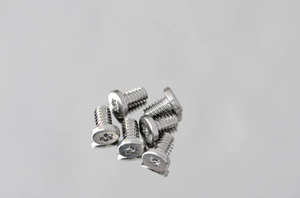 Closeup of small screws on metal — Stock Photo, Image