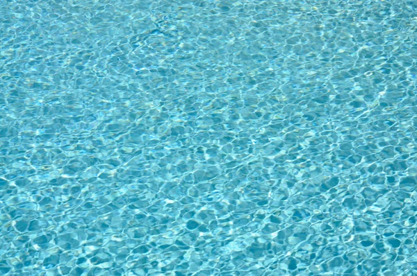 Light reflection on water surface in swimming pool — Stock Photo, Image