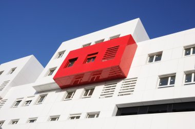 Modern red and white building in the city clipart