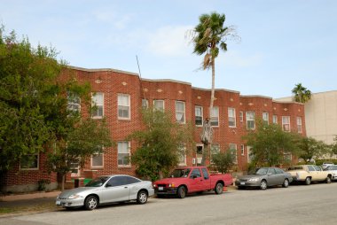 Cars parked in front of a house clipart