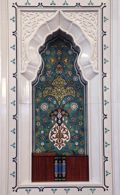 Oriental mosaic decoration in a mosque. Quran books in a shelf. Sultanate o clipart