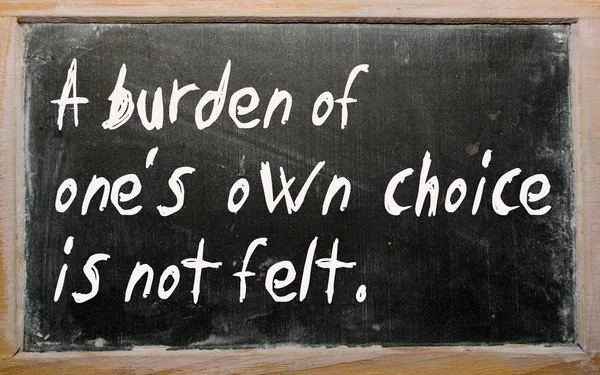 "A burden of one's own choice is not felt" written on a blac — Stock Photo, Image