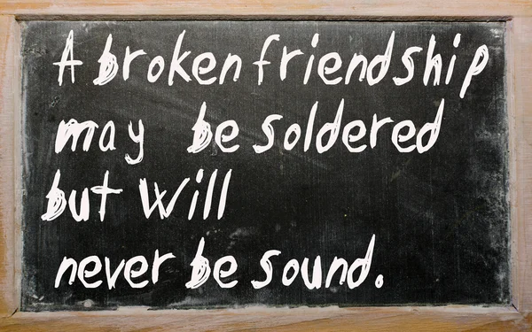 "A broken friendship may be soldered but will" written on a blac — Stock Photo, Image