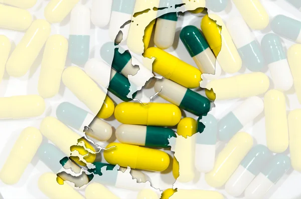 Konturkarta över Nederländerna med piller i bakgrunden — Stockfoto