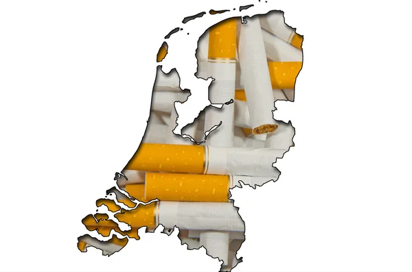 Übersichtskarte der Niederlande mit Zigaretten im Hintergrund — Stockfoto