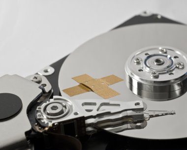 Hard disk drive with band-aid clipart