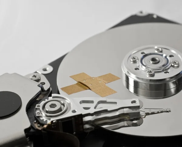 Hard disk drive with band-aid — Stock Photo, Image