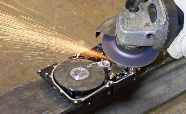 Angular grinder cleaning data from hard drive — Stock Photo, Image