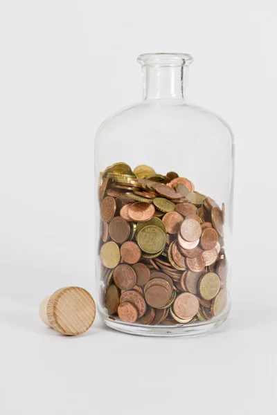 Monedas en botella de vidrio — Foto de Stock