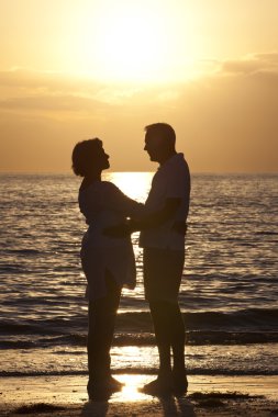 Senior Man & Woman Couple on Beach at Sunset clipart