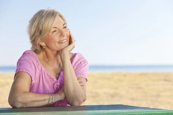 Thoughtful Attractive Senior Woman Sitting Outside at Table — Stock Photo, Image