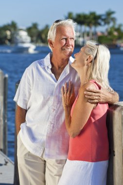 Happy Senior Couple On Vacation By Tropical Sea clipart