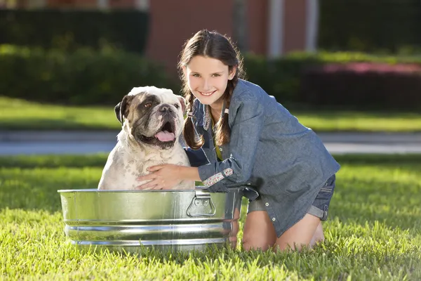 stock image Pretty Young Girl Washing Her Pet Dog In A Tub